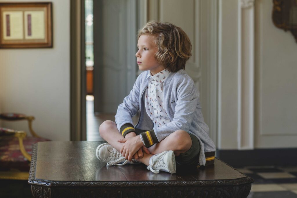 Boy in GYMP outfit sitting on the table