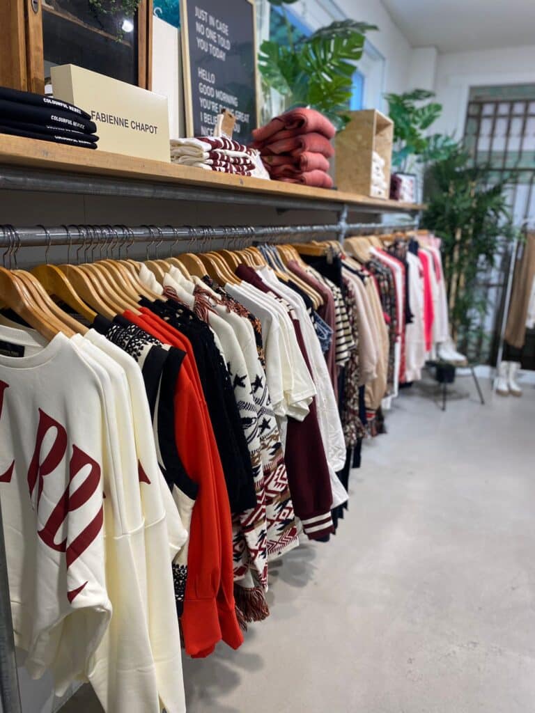 Clothes of different brands hanging in a store